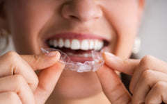 lady holding aligners