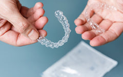 someone holding two aligners