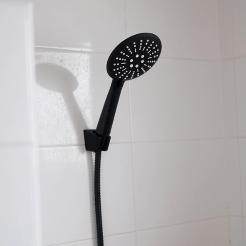 black shower head in a shower head holder