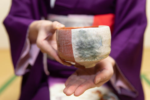 japanese style tea cup holding carefully hands