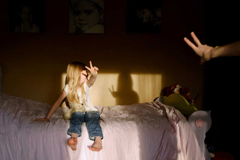 home blessings, a child posing in a dark room