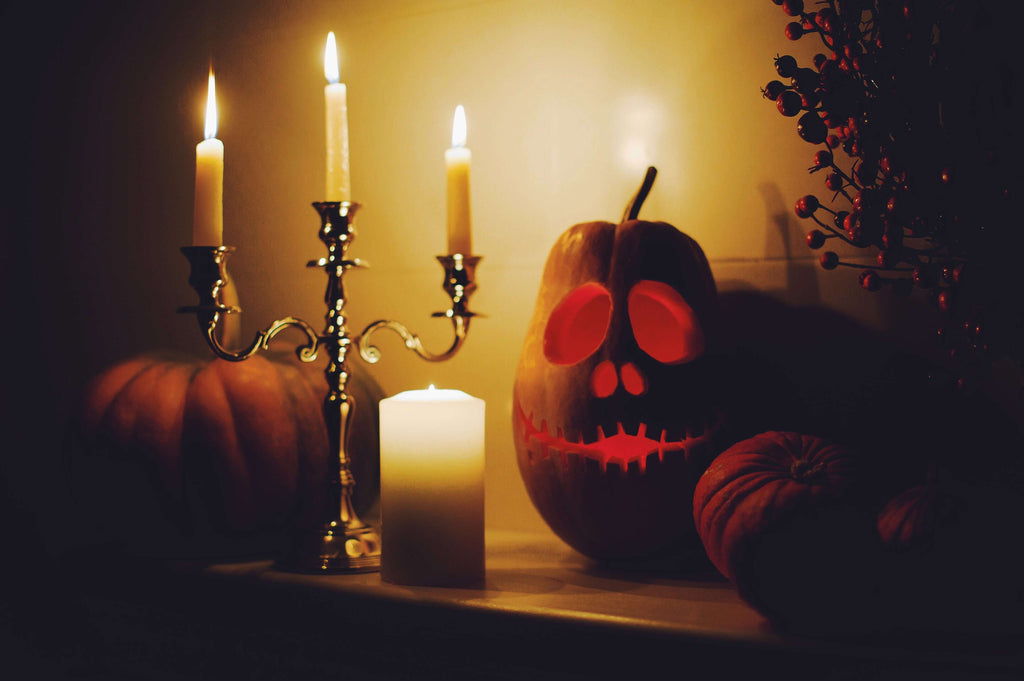 Witchy Halloween, carved pumpkins near candles.