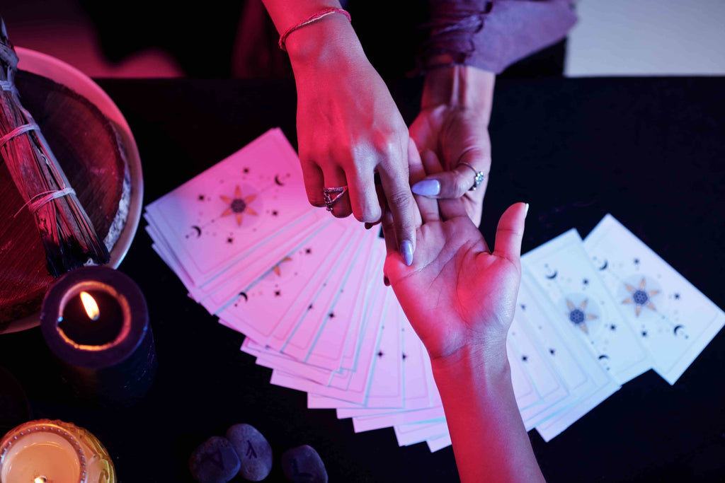 Love magic, a palm reading session with cards.