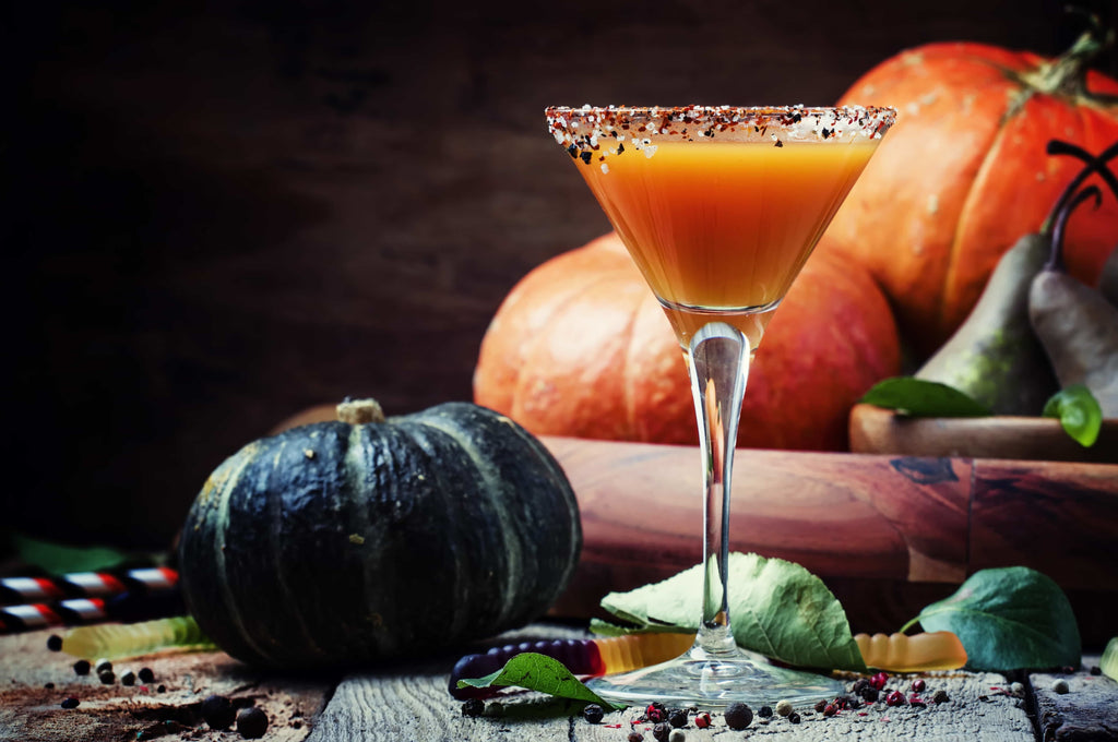 Witchy Halloween, an orange drink near pumpkins.