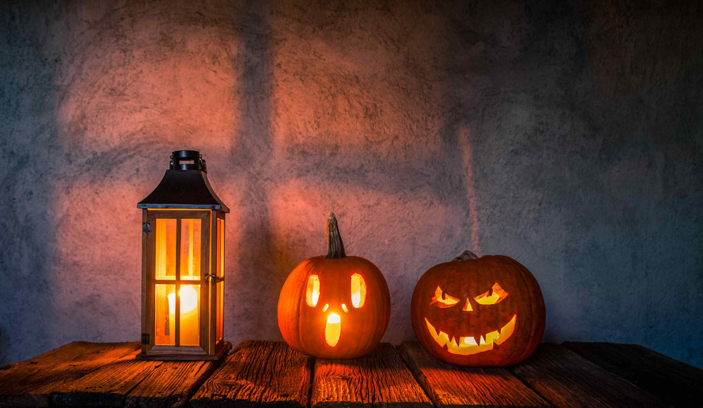 Halloween celebrations, a lantern and two carved pumpkins.