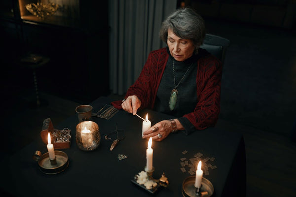 a woman performing a seance using tarot cards