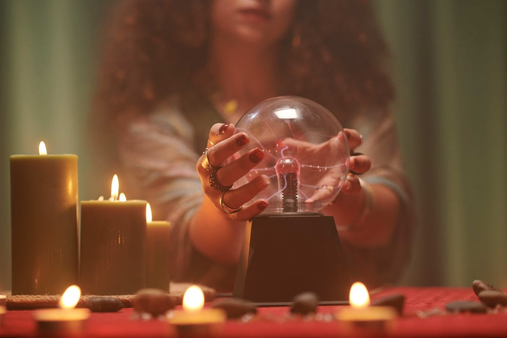 Halloween for adults, woman with crystal ball and candles.