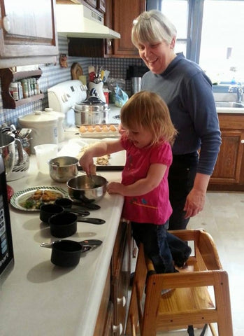 Beth and grand-daughter cooking