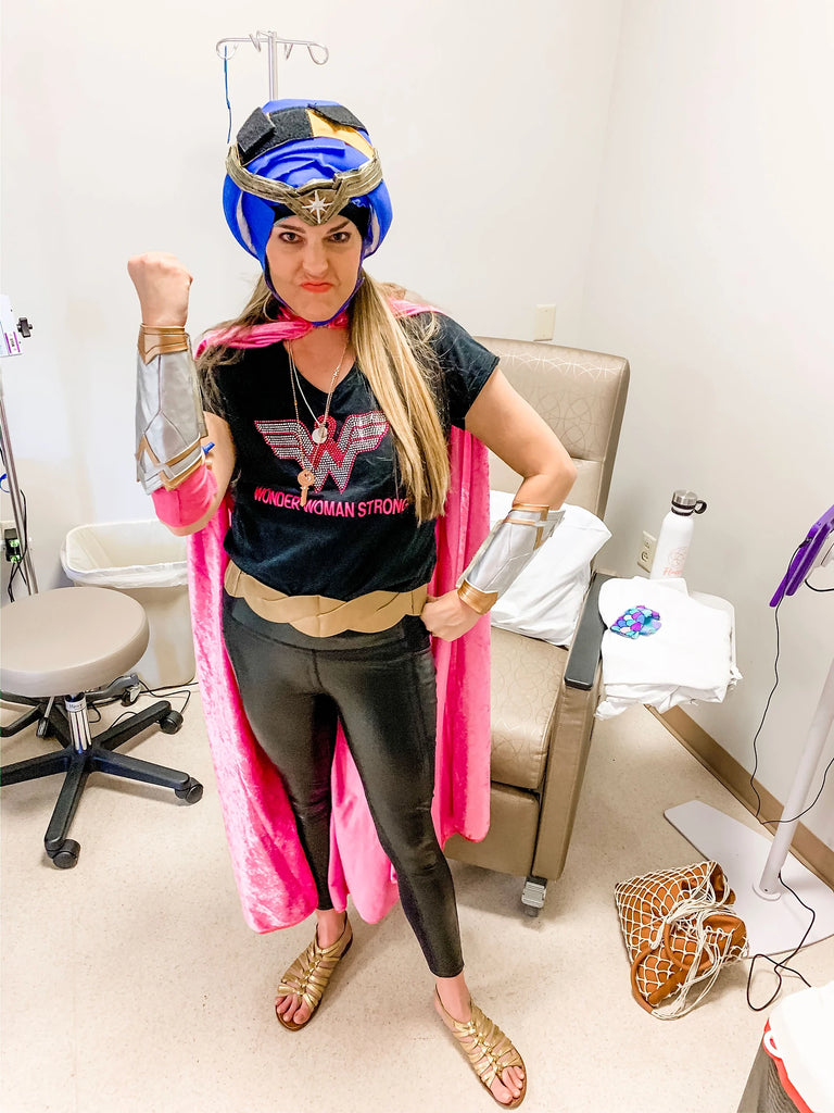 Dr. Christina Hibbert is a breast cancer WARRIOR dressed in pink and black Wonder Woman costume