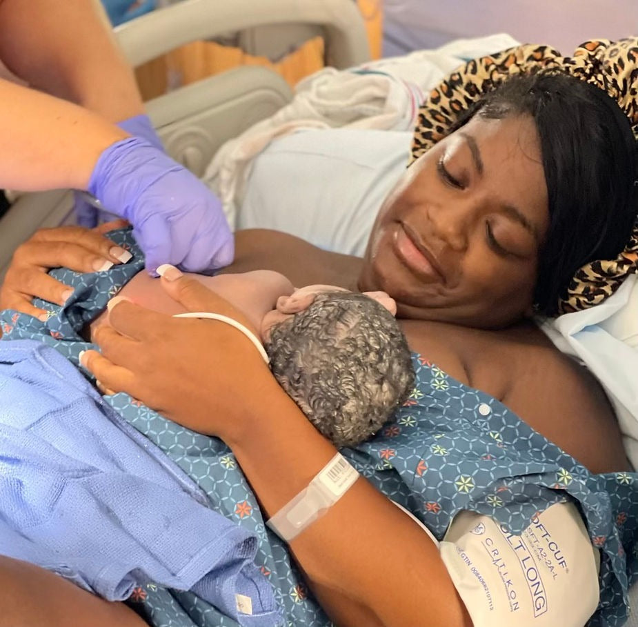 Photo of Ty’Erra and her newborn baby, Da’Lila, practicing skin-to-skin contact after delivery.