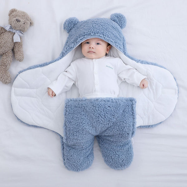 cute baby wrapped in blue baby bear swaddle