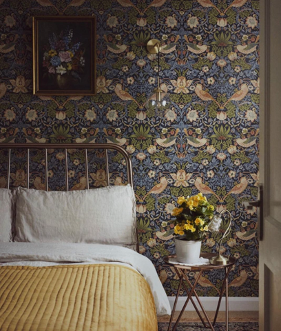 Brass bed with wallpaper