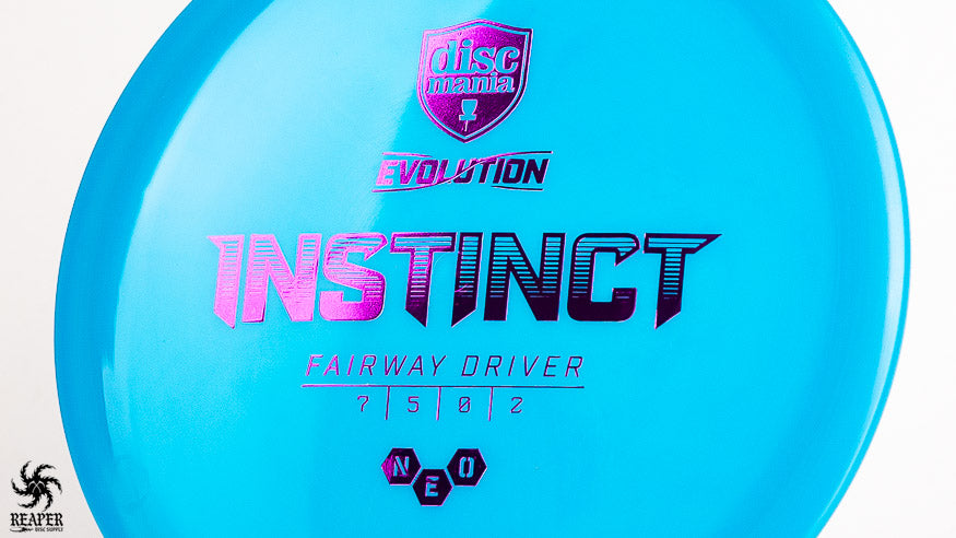 A blue Discmania Instinct with a purple stamp, shot with a white background