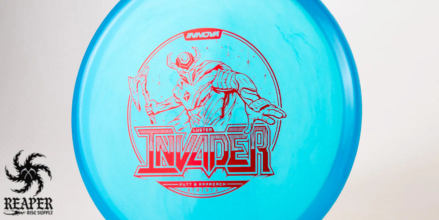 A blue Innova Champion Luster Invader with a red stamp