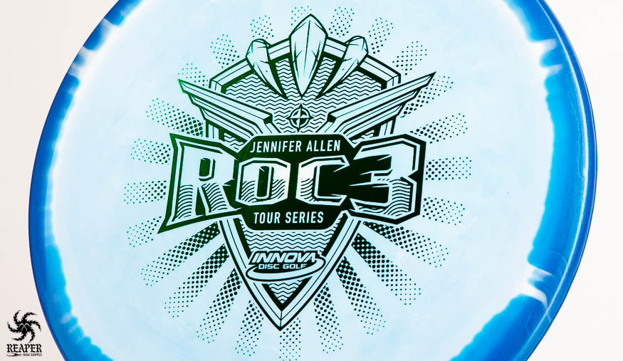 A blue Jennifer Allen Tour Series Innova Roc3 with green stamp shot inside a studio