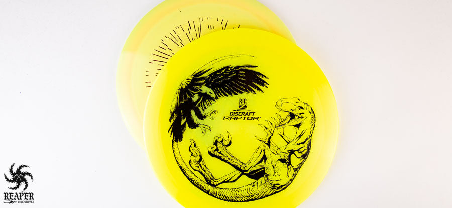 Discraft Raptor and Predator in yellow plastic on a grey background