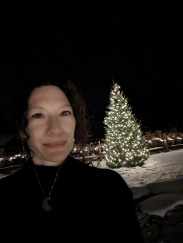 bombshell-art founder and artist, Heather Wilson, in a holiday tree selfie at Trapp Lodge