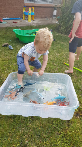 water play toys in a tub sensory activity