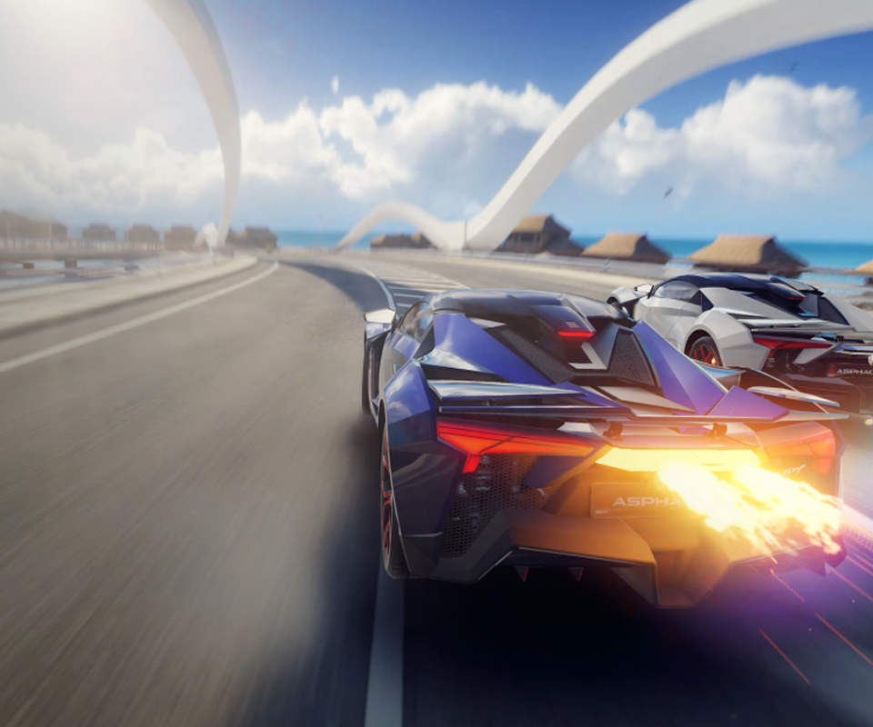 A frame from a video game showing a car speeding along a winding road.