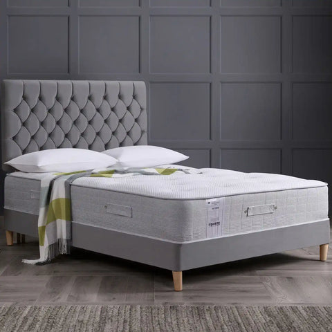 Memory foam mattress on grey frame bed