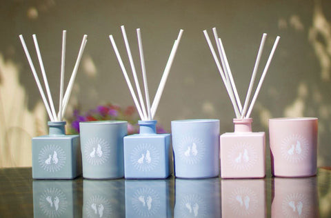 Pink, blue and grey scented candles and room diffusers