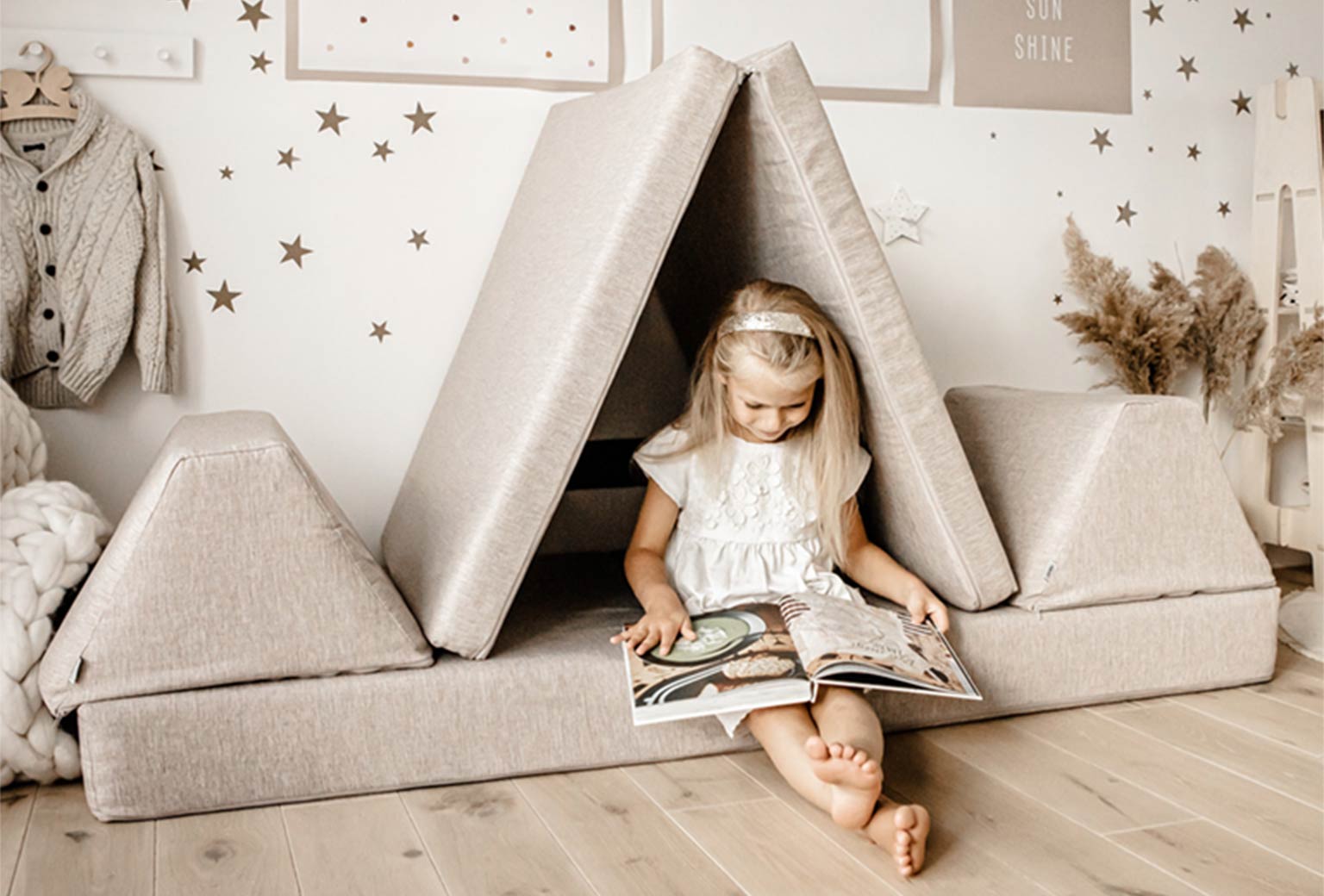 Girl sitting on a Monboxy sofa reading a book