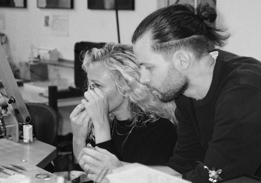 Co-founder Sarah Munro and Robert Grynkofki inspect diamonds in Sarah & Sebastian design studio.