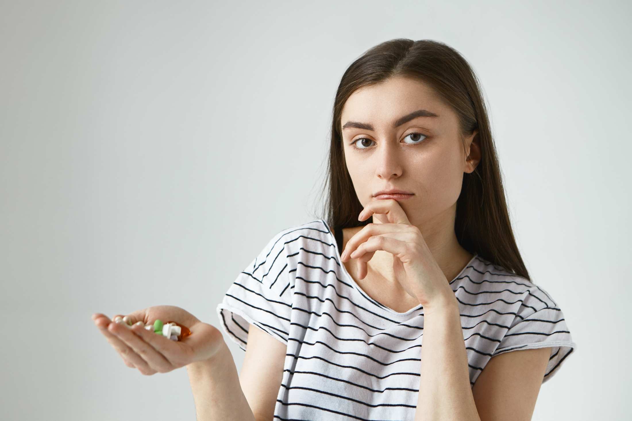 A young girl with dietary supplements.