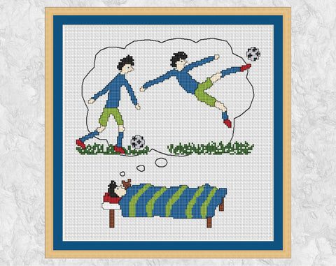 Footballing Dreams cross stitch pattern - picture of a boy lying in bed dreaming of becoming a top football or soccer player - shown with frame