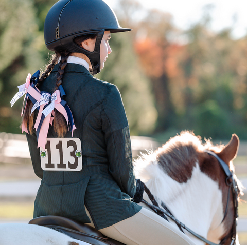 pinsnickety horseshoe horse show number pins on a rider's hunt coat