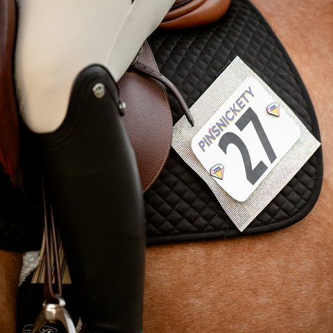 pinsnickety gem horse show number pins on a hunter's schooling saddle pad