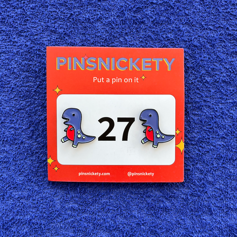 pinsnickety t-rex horse show number pins on a blue background
