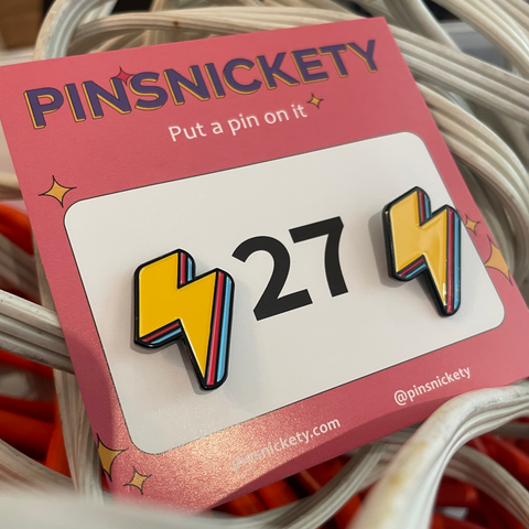 pinsnickety lightning bolt horse show number pins in special edition electric yellow in a bin of extension cords