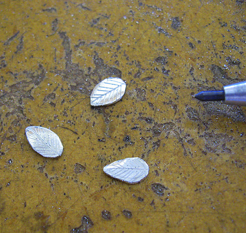 Hand-cut, engraved sterling silver leaves