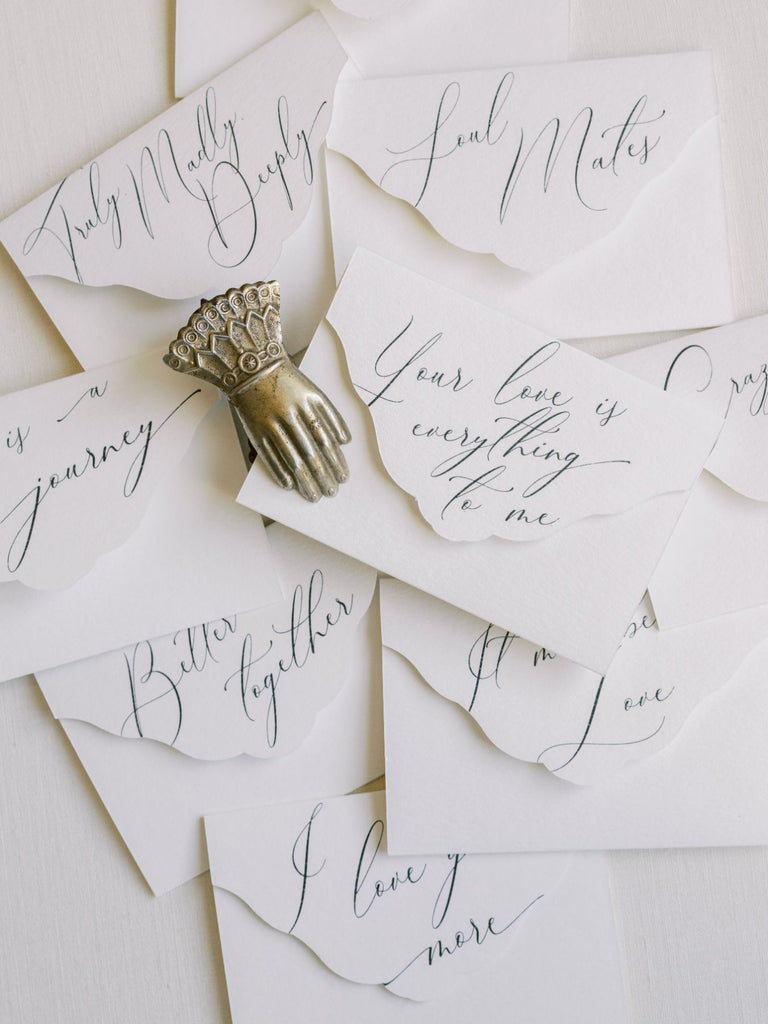Layered love notes with calligraphy details.