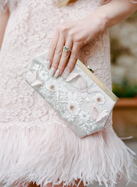 White bridal bag embroidered with floral pattern by the Bella Rosa Collection