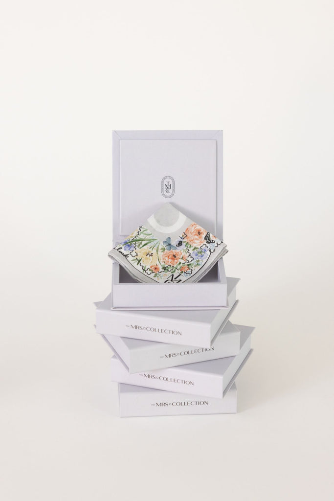 Stack of t gift boxes with bridal handkerchiefs inside