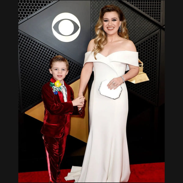 Kelly Clarkson in a white gown on the red carpet with son.