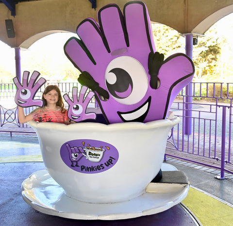 A child in Thorpe Park tea cup ride decorated with Dobble