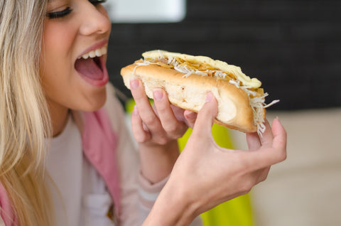 girl eating a hot dog