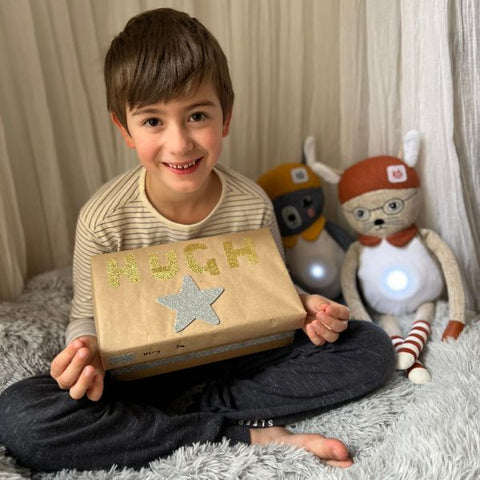 Boy smiling with worry box and Brave and Able