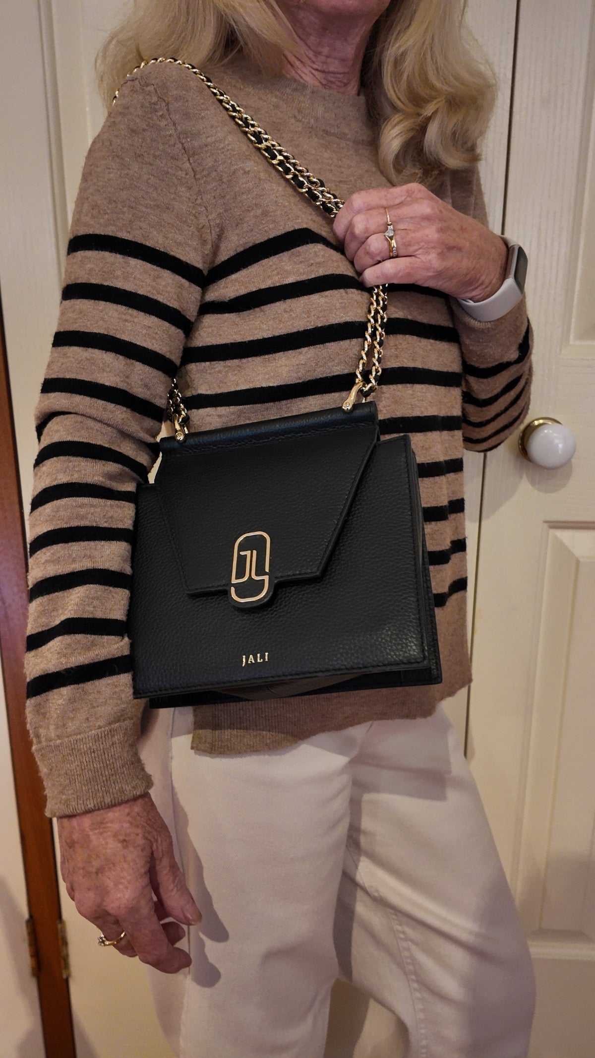 Happy JALI customer carrying her Cleopatra Bag, smiling and confident, showcasing the bag’s timeless appeal and premium craftsmanship.