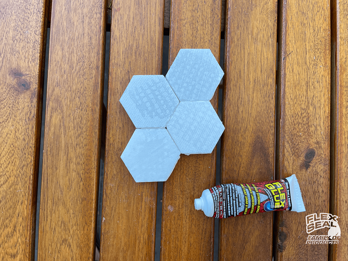 Keep attaching tiles around the center tile, and add Flex glue between any edges