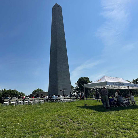 Bunker Hill Monument made from Quincy Granite Naturalization ceremony on flag day helping 50 immigrants become US citizens With Chair Rentals From BZ Tent Rentals