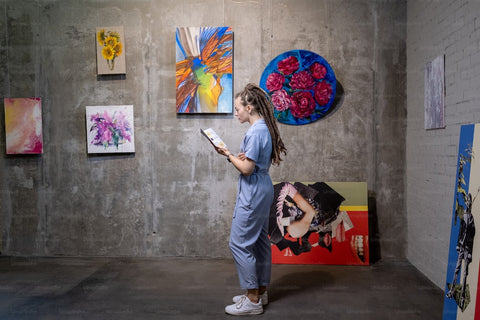 girl standing in a painting with paintings