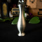 A small, flared, pewter flower bud vase