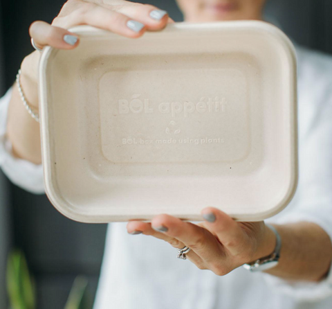Woman holding a recycled dinner box