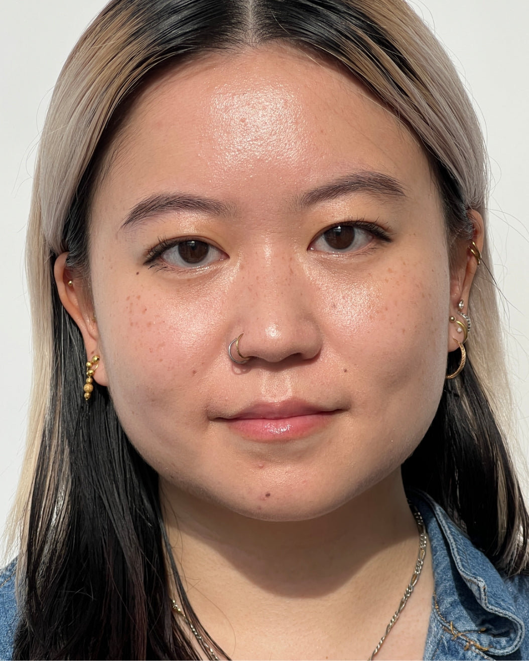 Portrait of a completed makeup look—model wearing puppy eyeliner on a white background