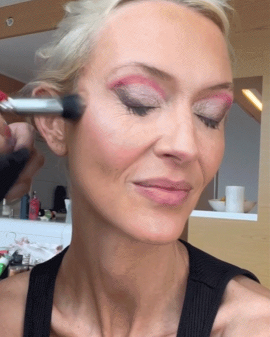 Milk Makeup cofounder Zanna Roberts-Rassi gets blush and lip liner applied to her face by a makeup artist