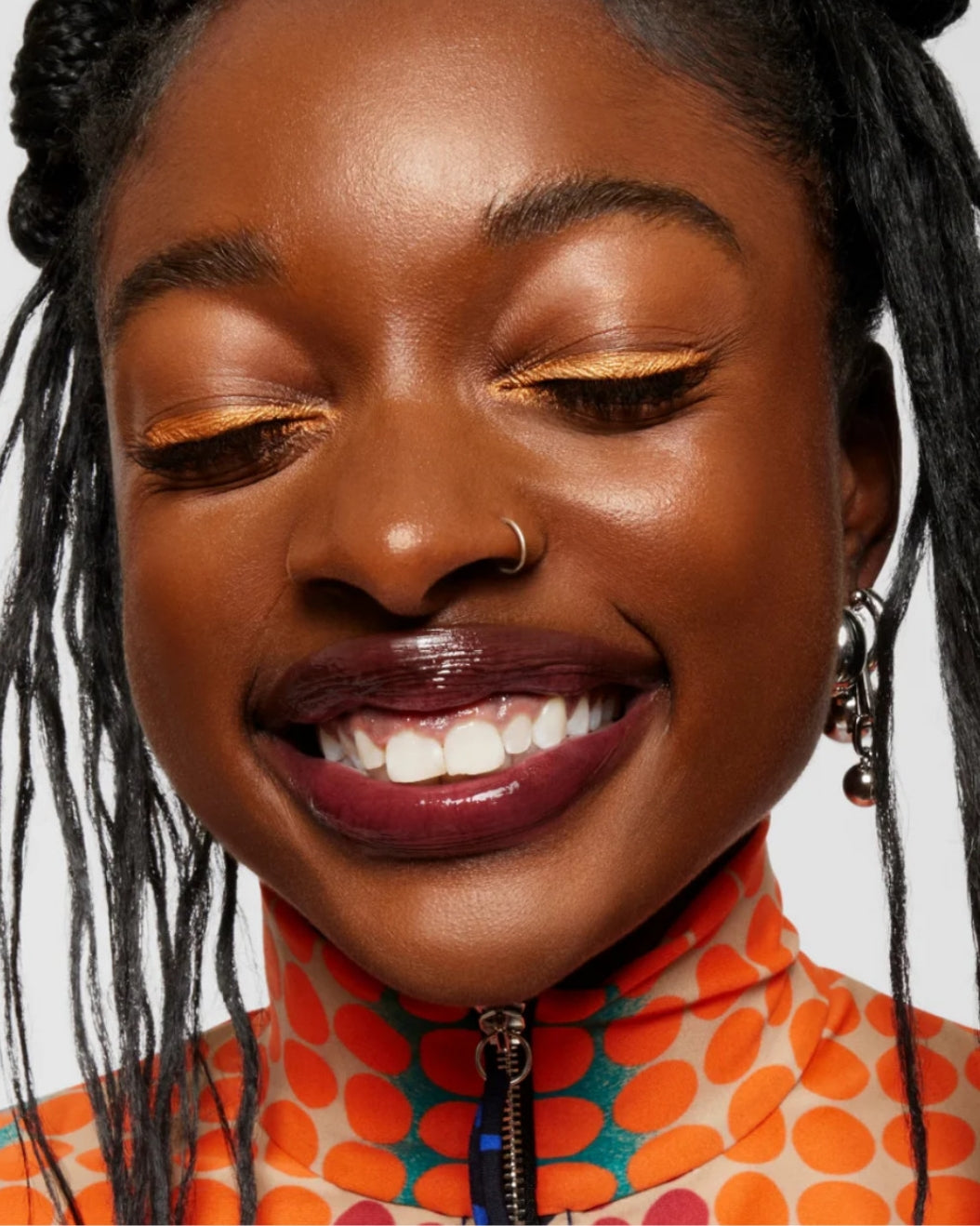 Model with orange winged eyeliner wears Milk Makeup Infinity Long Wear Eyeliner in Limitless as a lip liner on a white. background